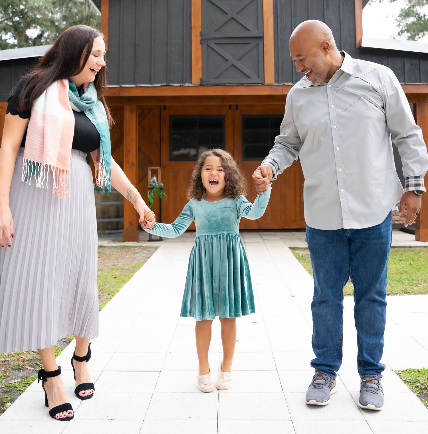 Family feet portrait on white tile showing different shoes and styles walking together.