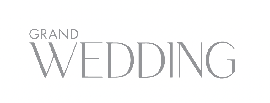 Elegant white text reading 'Grand Wedding' on a light gray textured background with decorative flourishes.