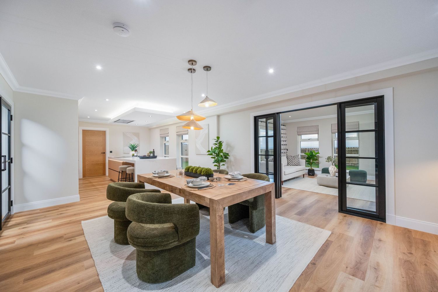Modern living area with hardwood floors, recessed lighting, and contemporary furnishings.