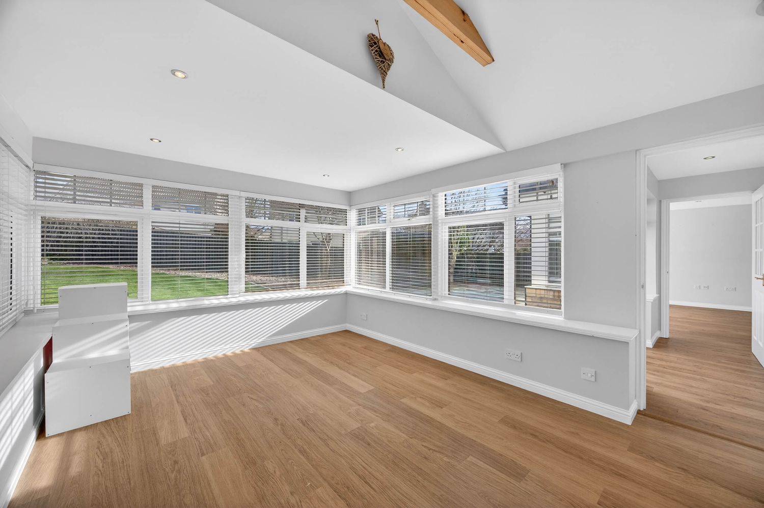 Panoramic view of an elegant living space with vaulted ceilings and exposed wooden beams.