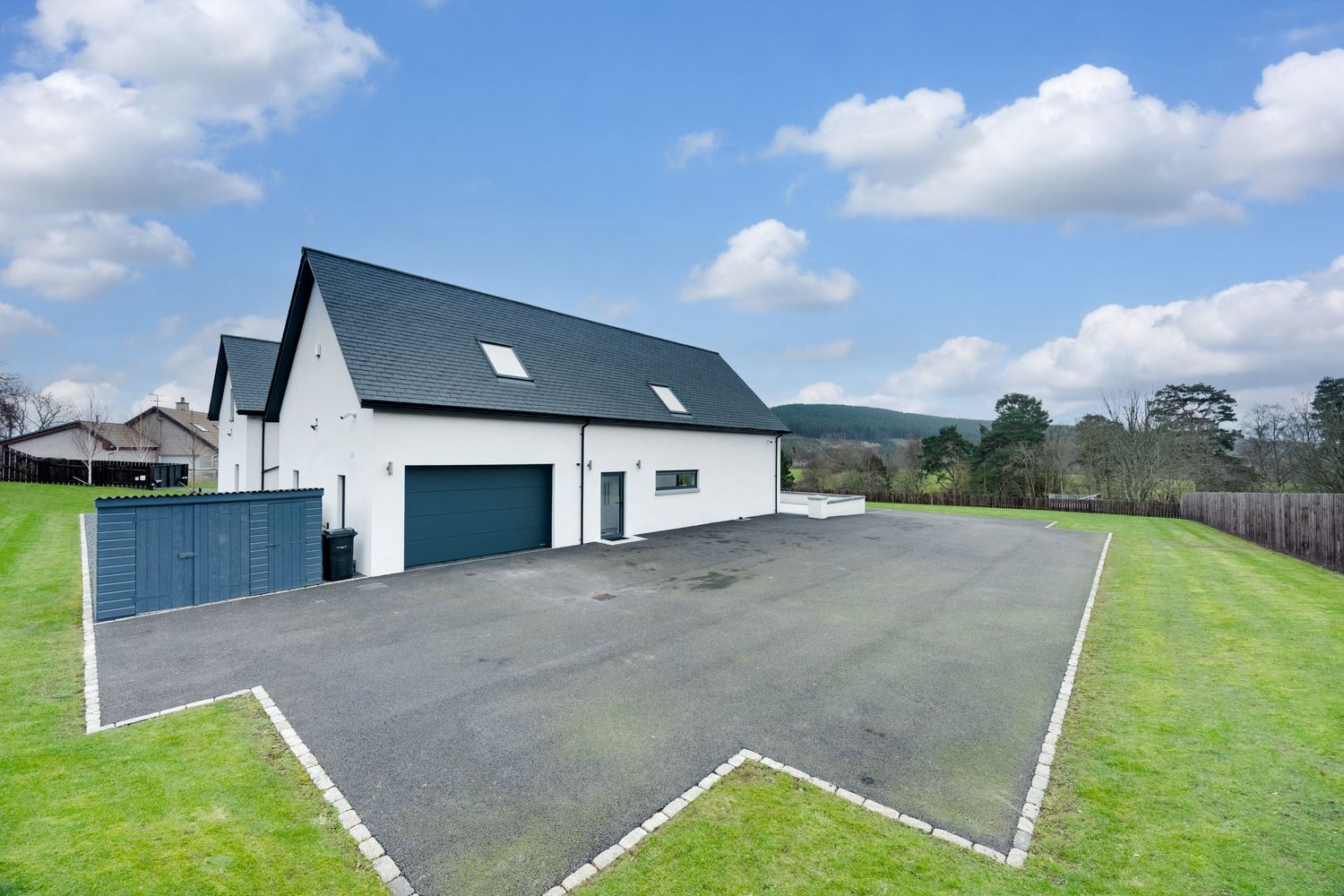 A series of photos showing a paved driveway leading to a modern house with white walls and a blue door in a rural setting.