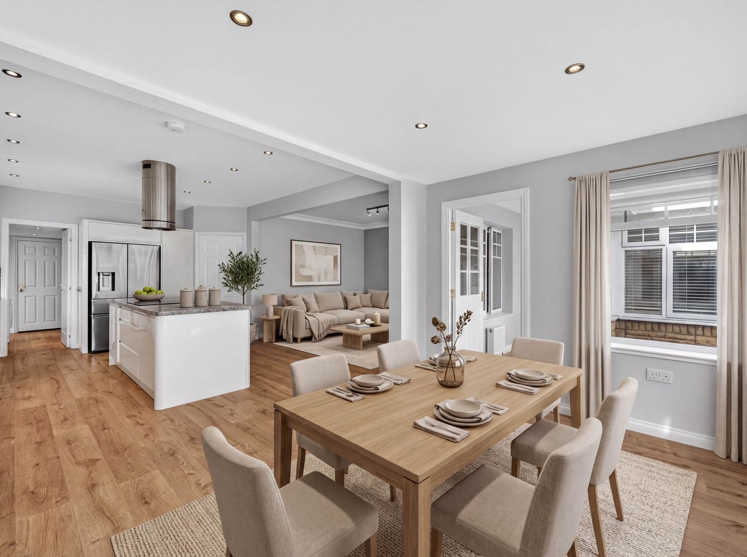 Contemporary dining area with neutral furniture and wooden flooring in an open-plan setting.