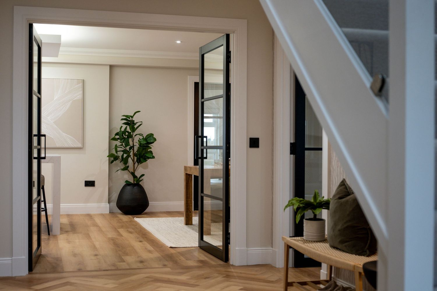 Bright white hallway with modern lighting fixtures and minimalist design elements.