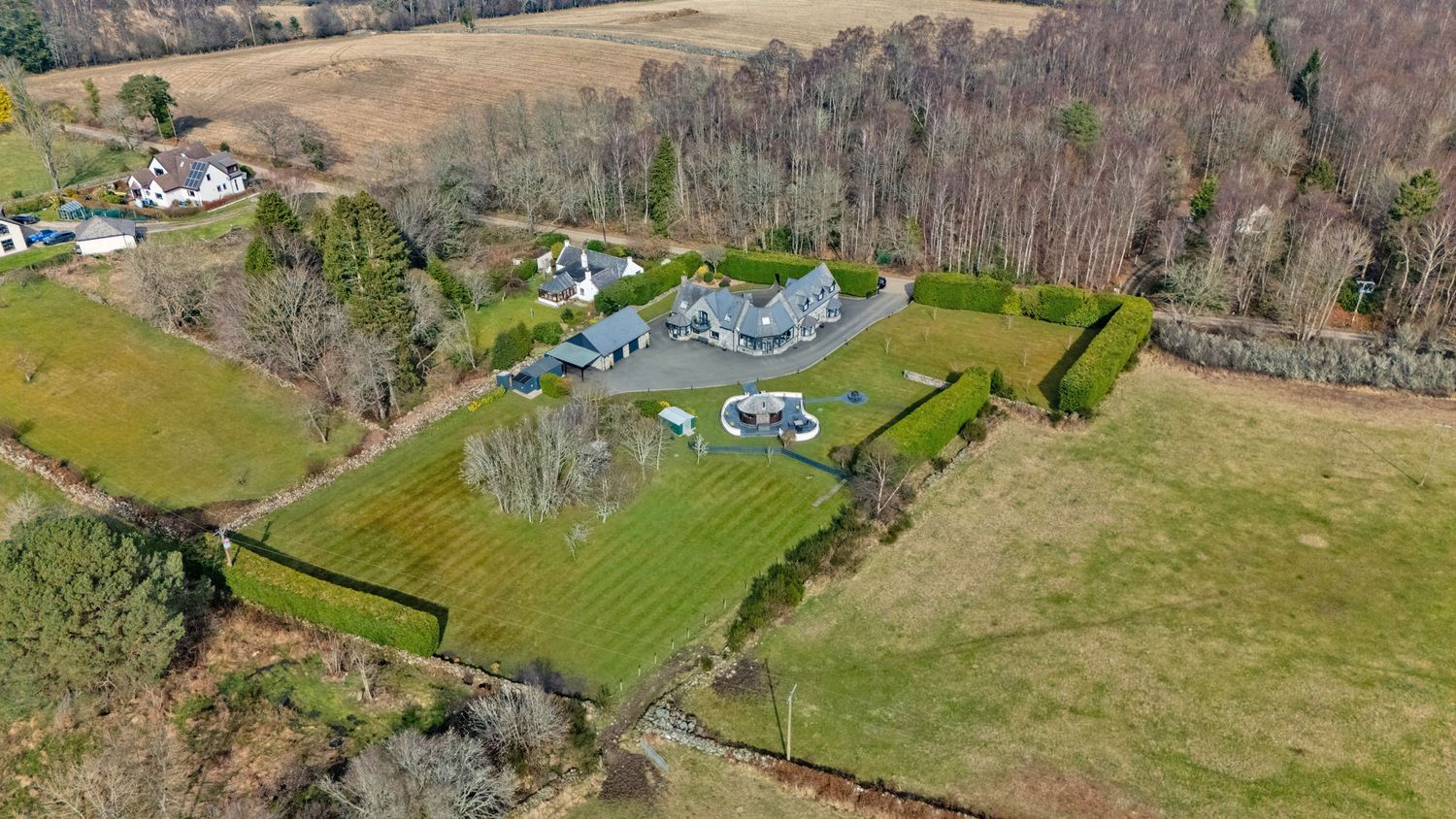 Aerial view of rural countryside showing scattered homes and agricultural fields.