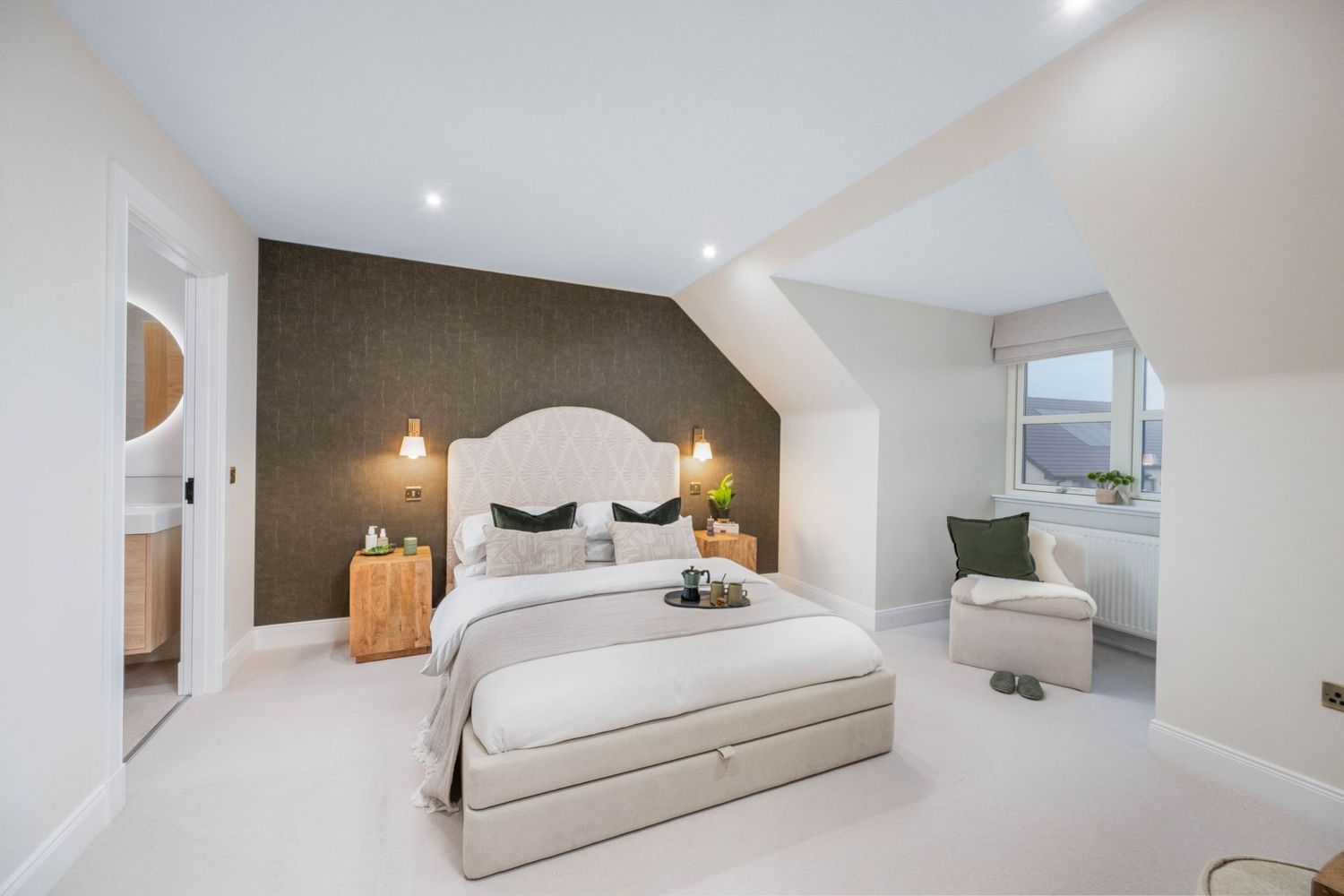 Bright attic bedroom with sloped ceiling and minimalist decor in white and gray.