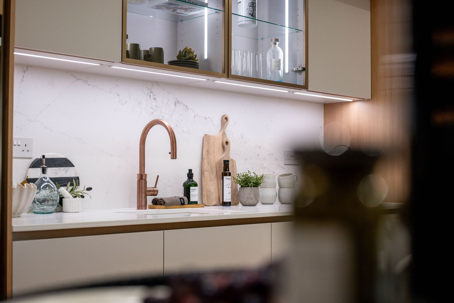 Close-up view of sleek kitchen shelving and cabinet details with ambient lighting.