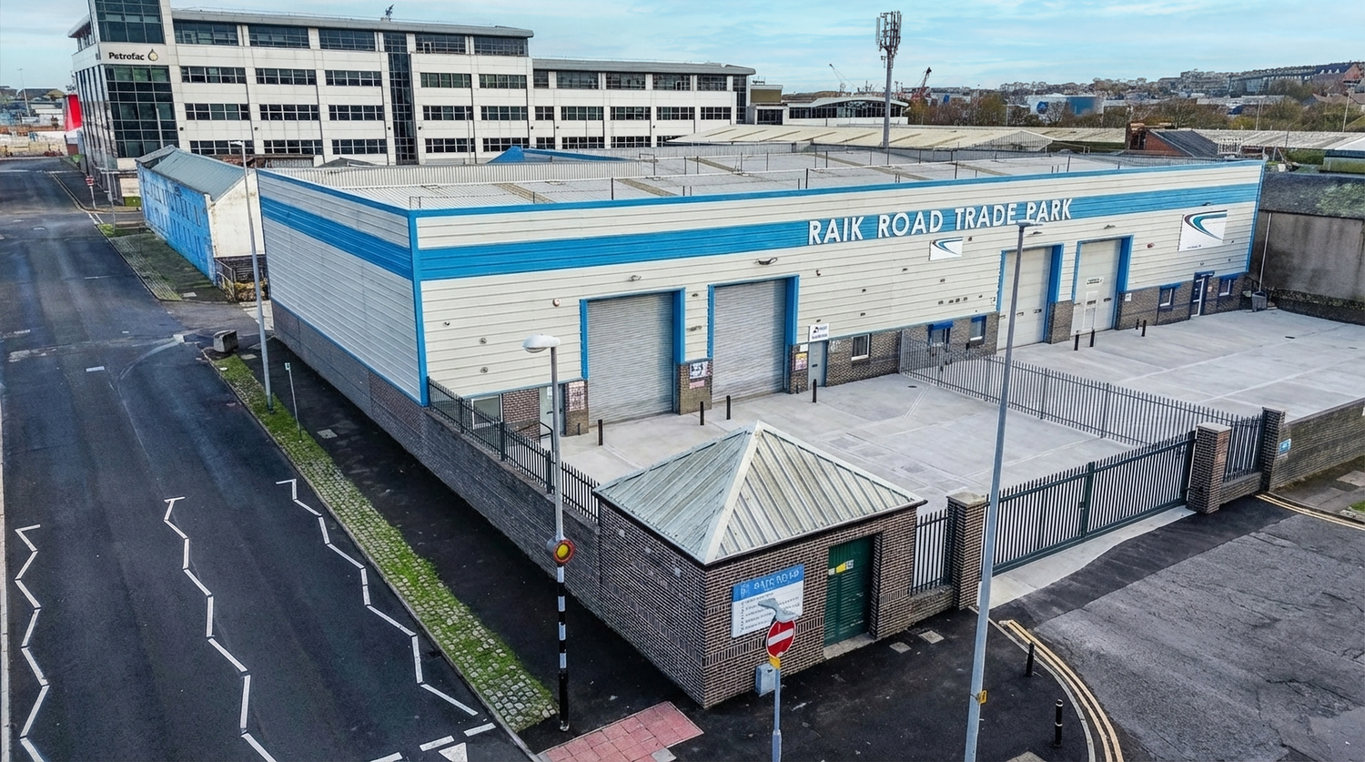 Panoramic shot of commercial buildings and loading docks in an industrial park.