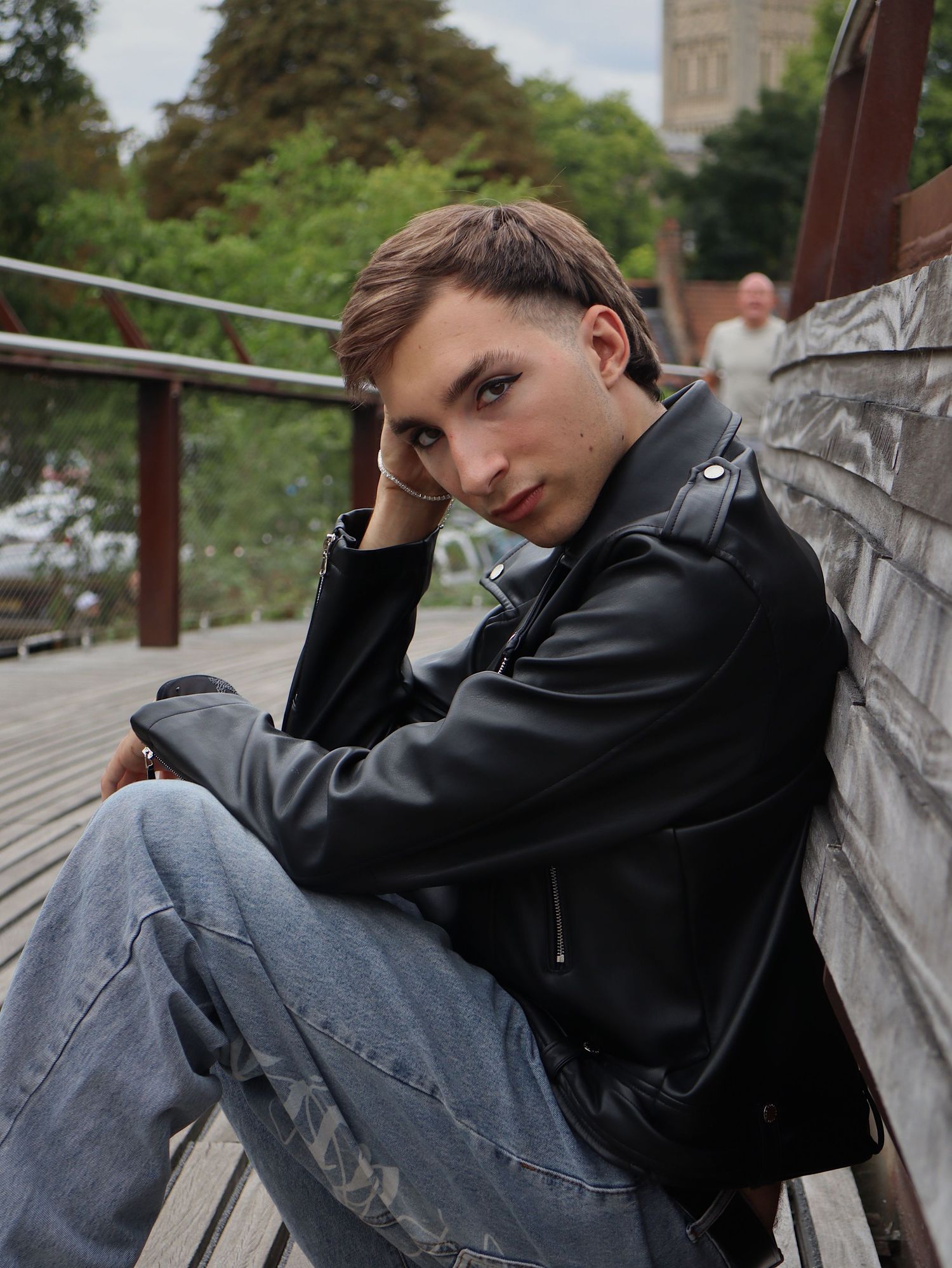 Adam resting up against a bridge.