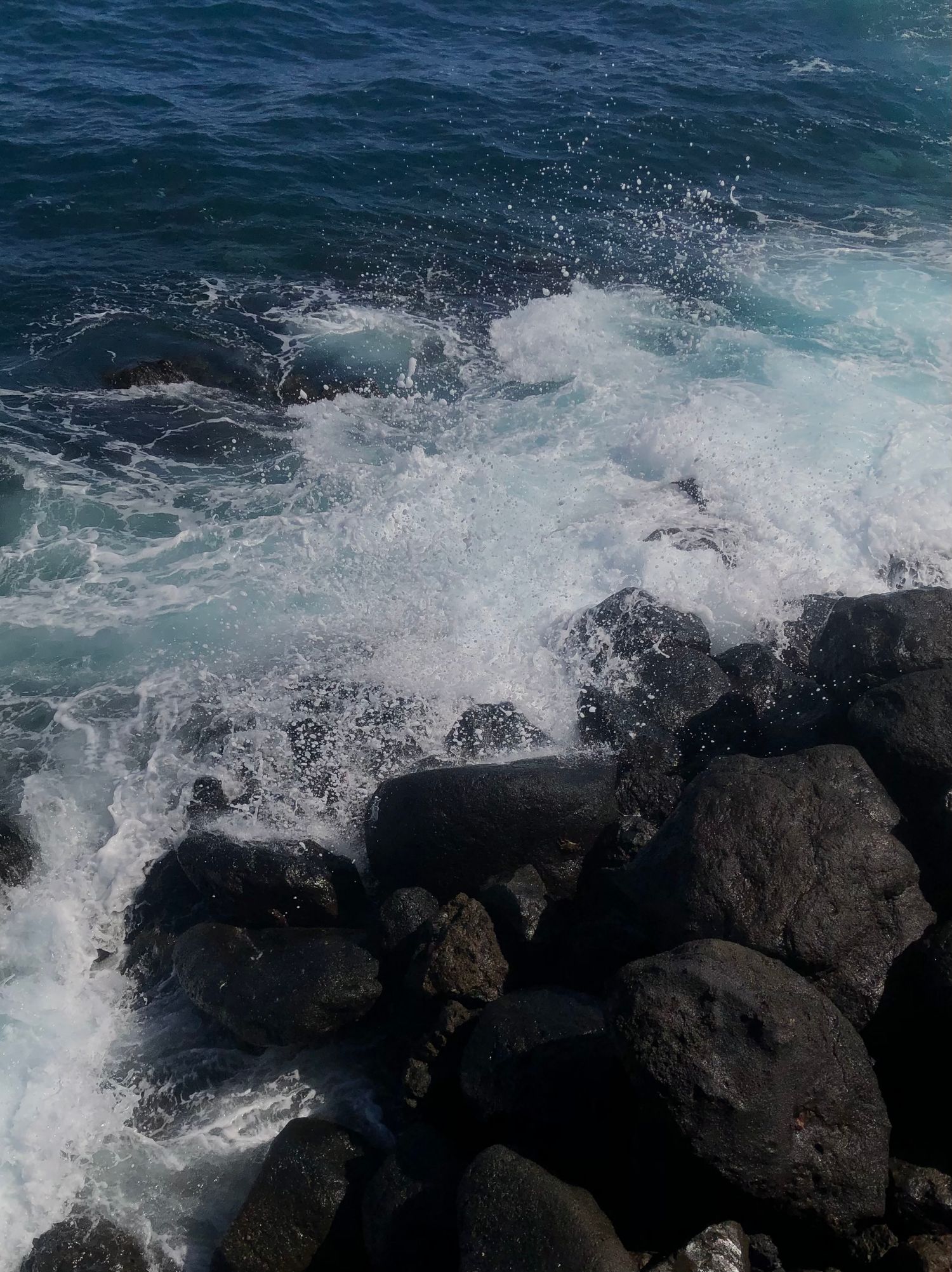 Waves crashing against rocks.