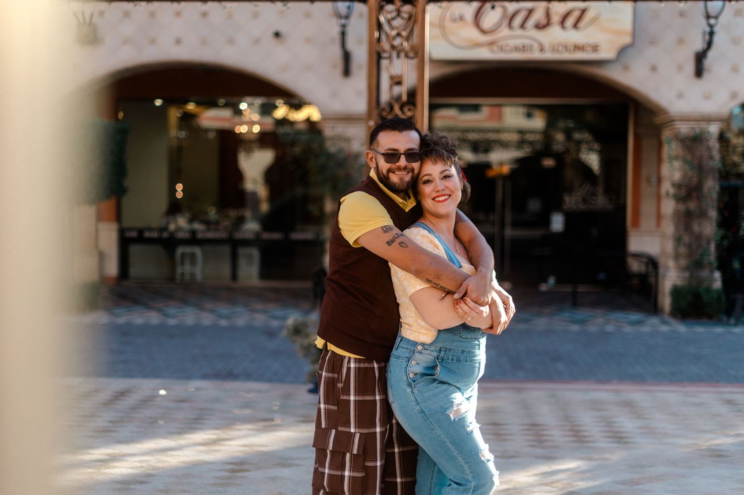 Happy couple hugging and laughing in front of Casa Cigars and Lounge.