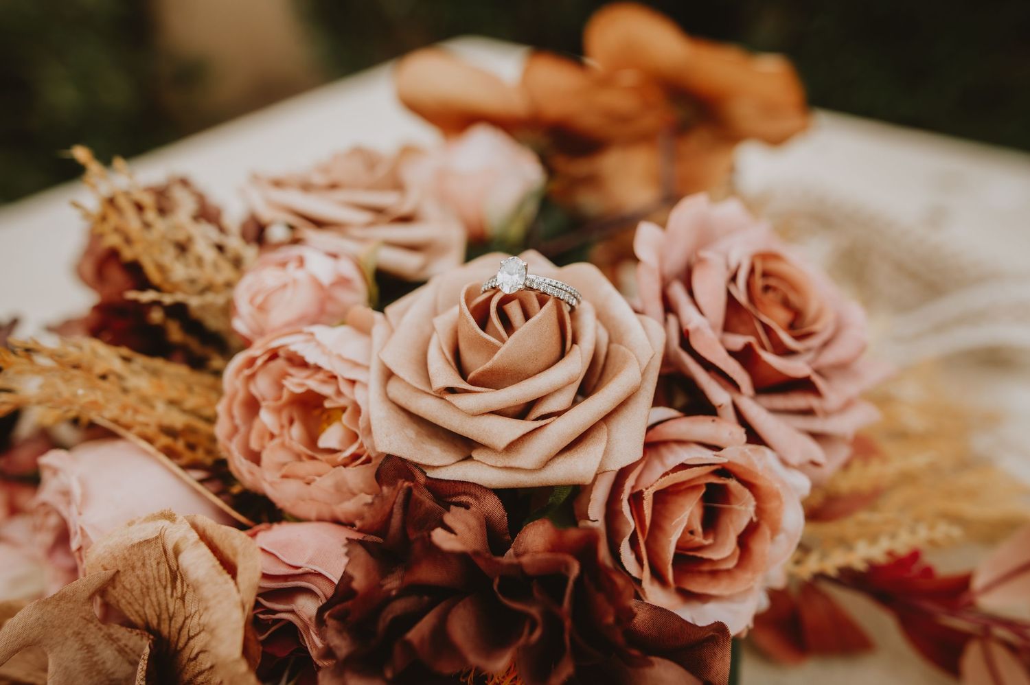 Beautiful arrangement of dusty pink and mauve roses with dried florals for a romantic wedding bouquet.