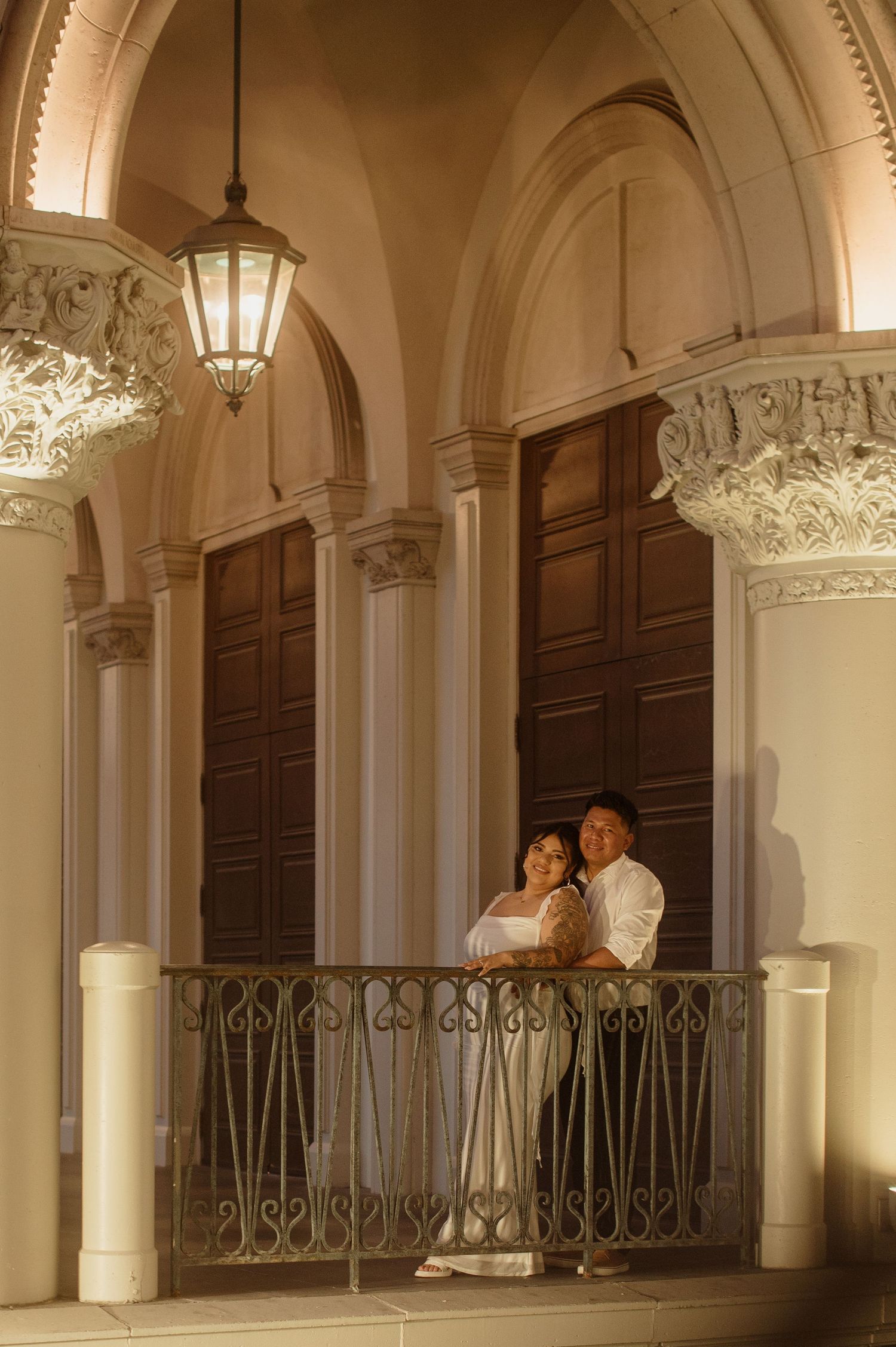 Couple romantically posed on a balcony under glowing lanterns at The Venetian Las Vegas.