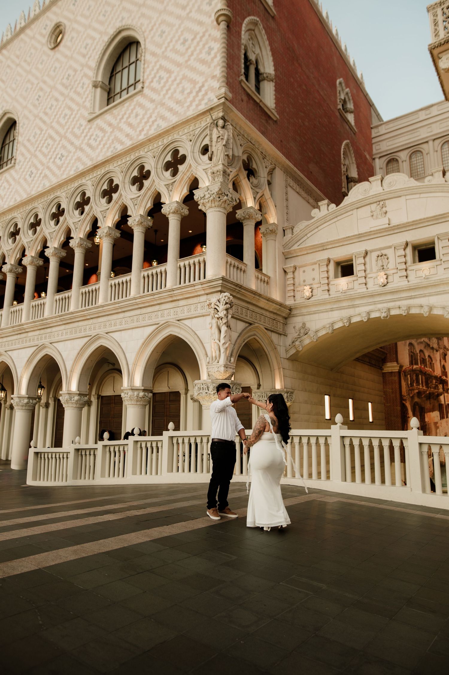 Couple shares romantic dance on bridge outside The Venetian resort in Las Vegas.