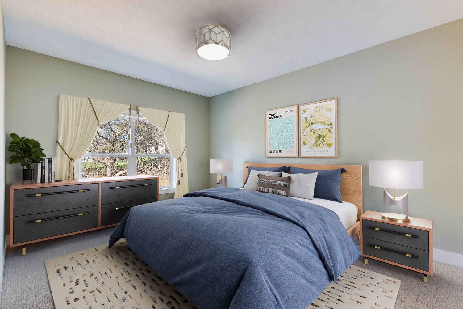 Cozy bedroom with sage green walls, blue bedding, wooden furniture, and natural light from a curtained window.