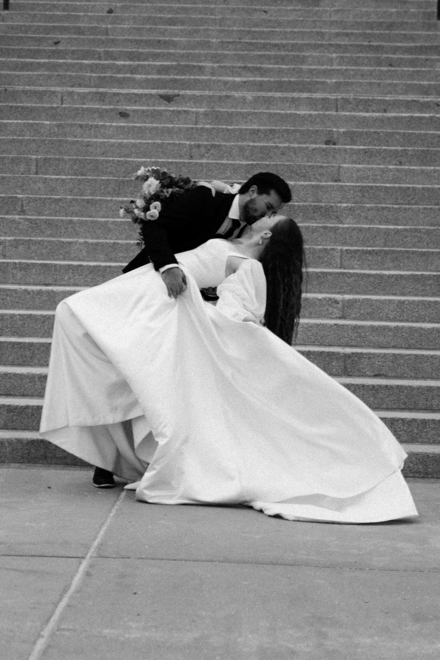 Black and white photo sequence showing two people laying on concrete steps.