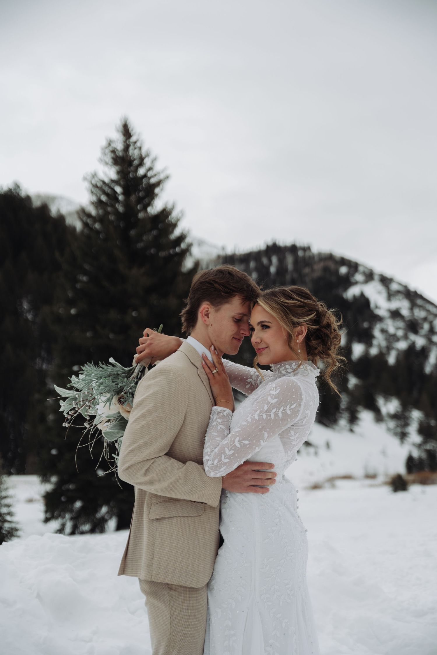 Winter wedding photography session in a snowy mountain landscape.