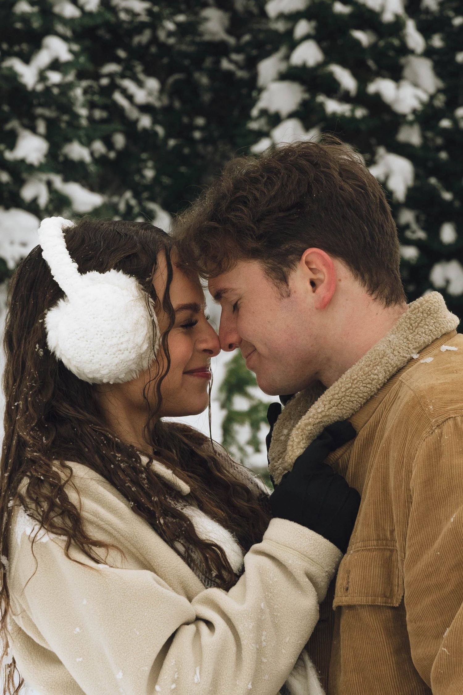 A romantic winter moment between two people in the snow.