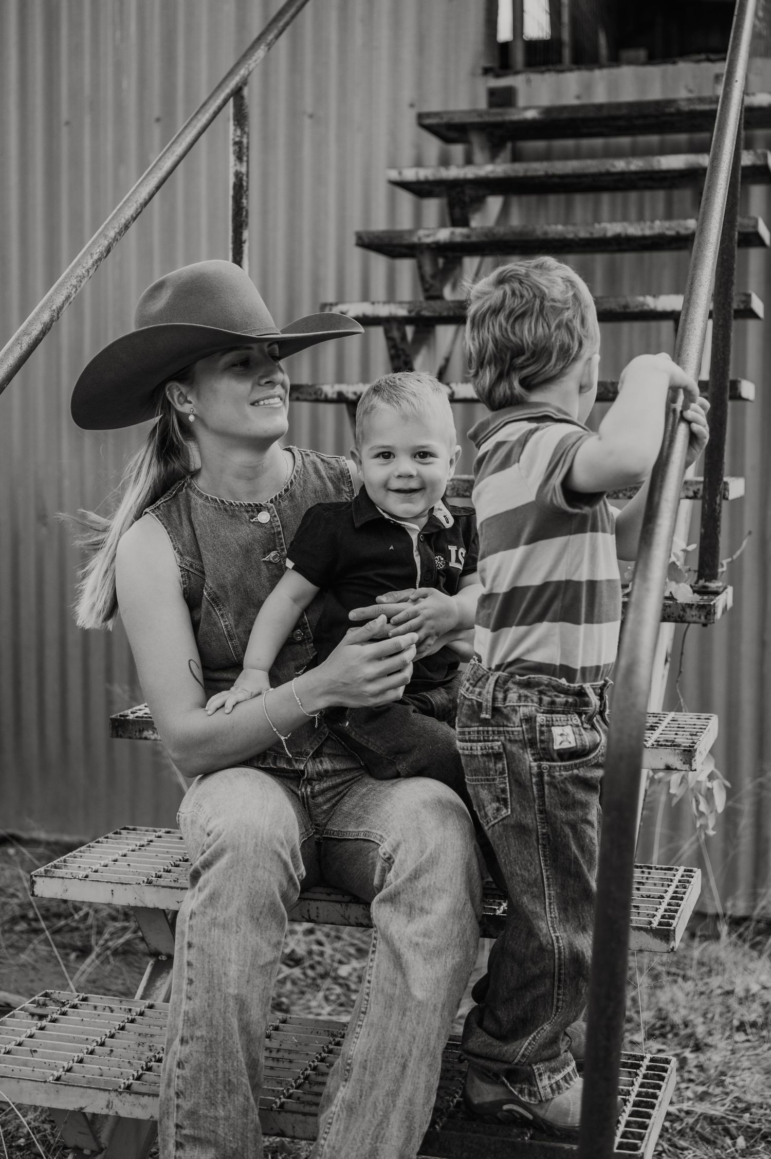 A black and white photo series shows candid moments of a parent and child sitting together on outdoor steps.