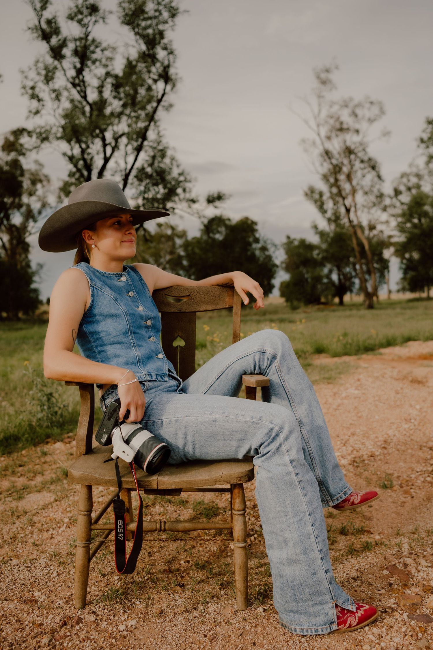 A series of photos showing someone in denim overalls and red shoes sitting casually on a wooden chair outdoors.