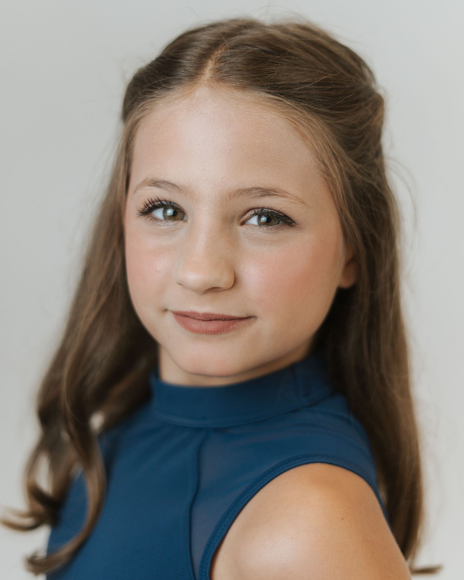 A portrait series in varying angles shows a young person with long brown hair wearing a blue top against a light backdrop.