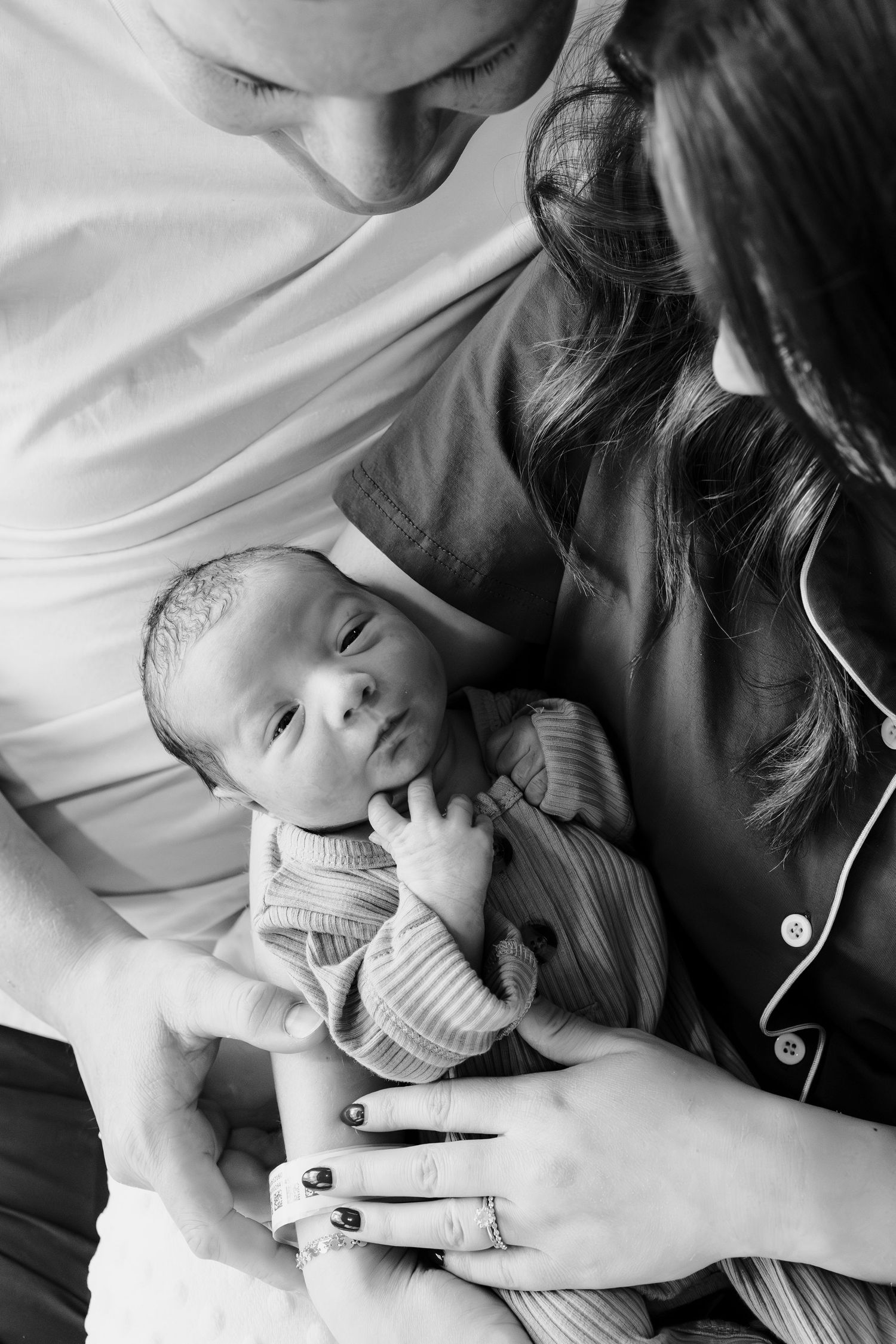 A touching sequence of black and white photos showing tender moments between parent and newborn baby.