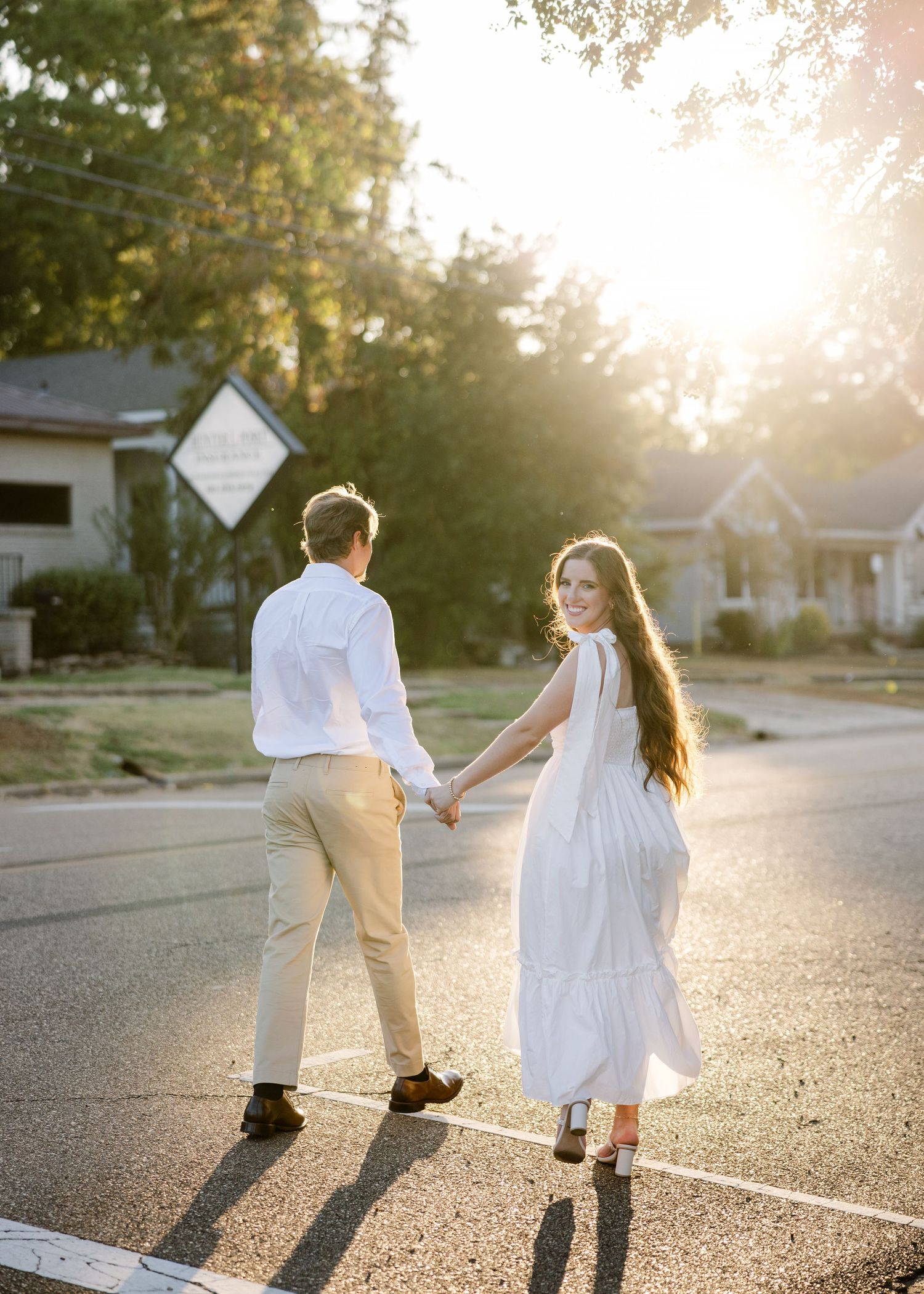 Romantic couple holding hands while walking at sunset.