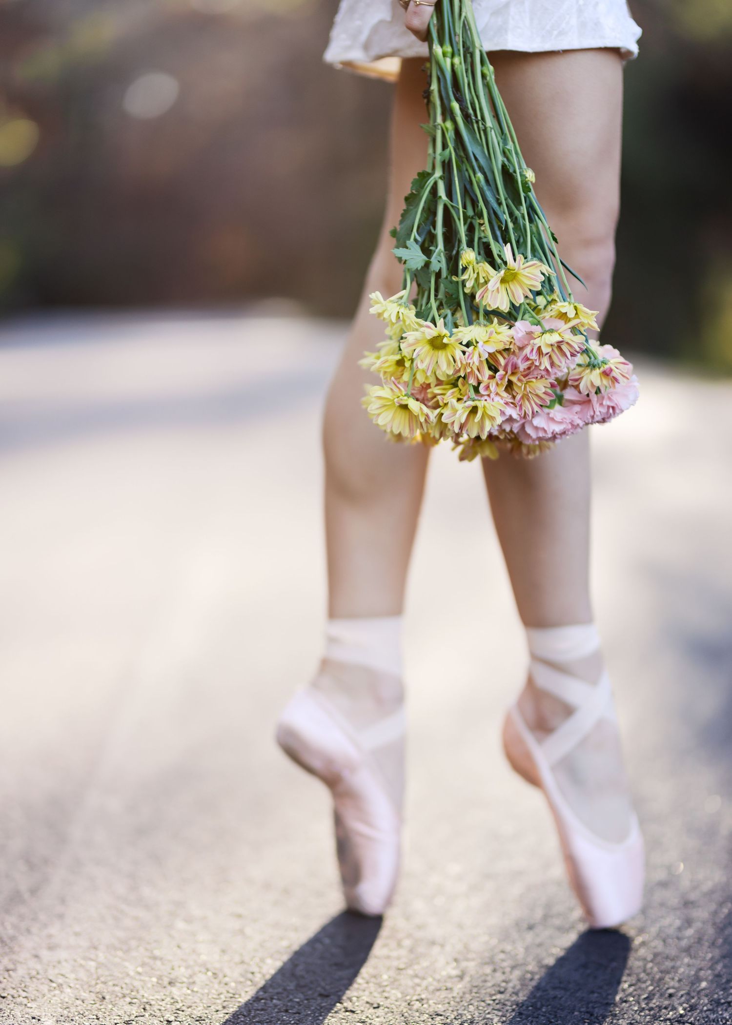 A sequence of cropped photos showing legs in white socks holding fresh yellow daffodils against a blurred outdoor background.
