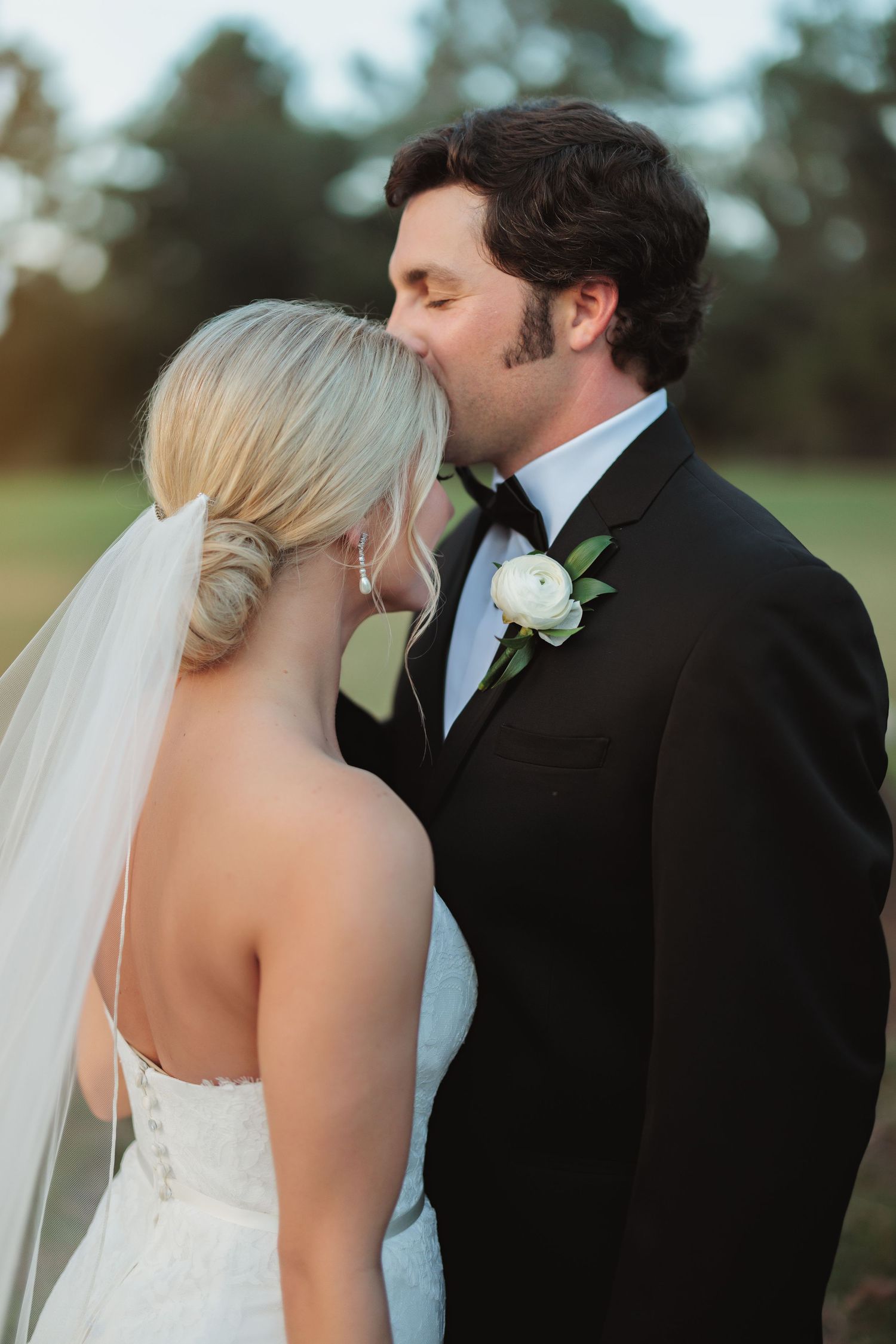 Intimate wedding couple portraits at sunset with soft lighting.