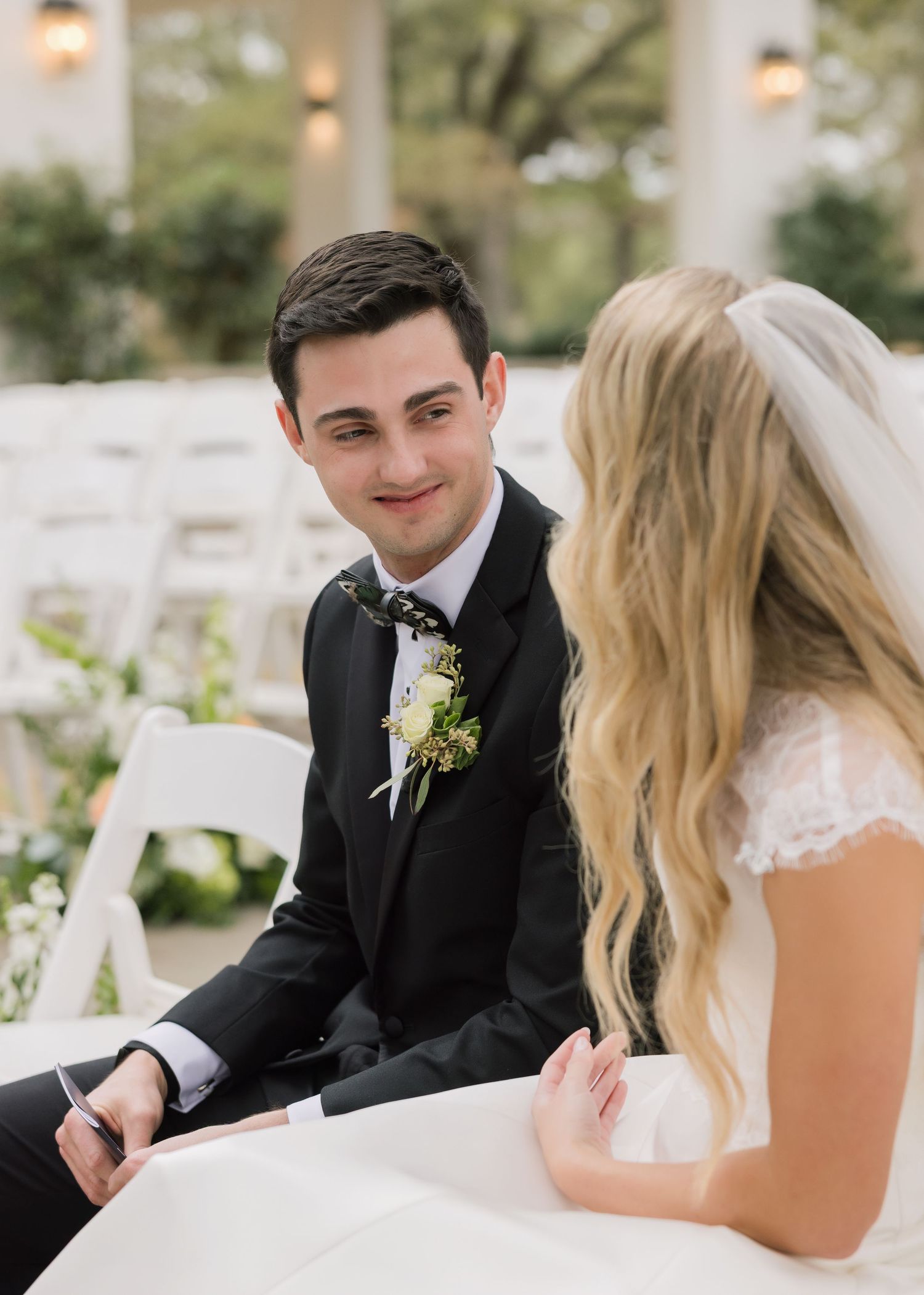 A bride and groom share intimate moments and laughter during their wedding photo session.