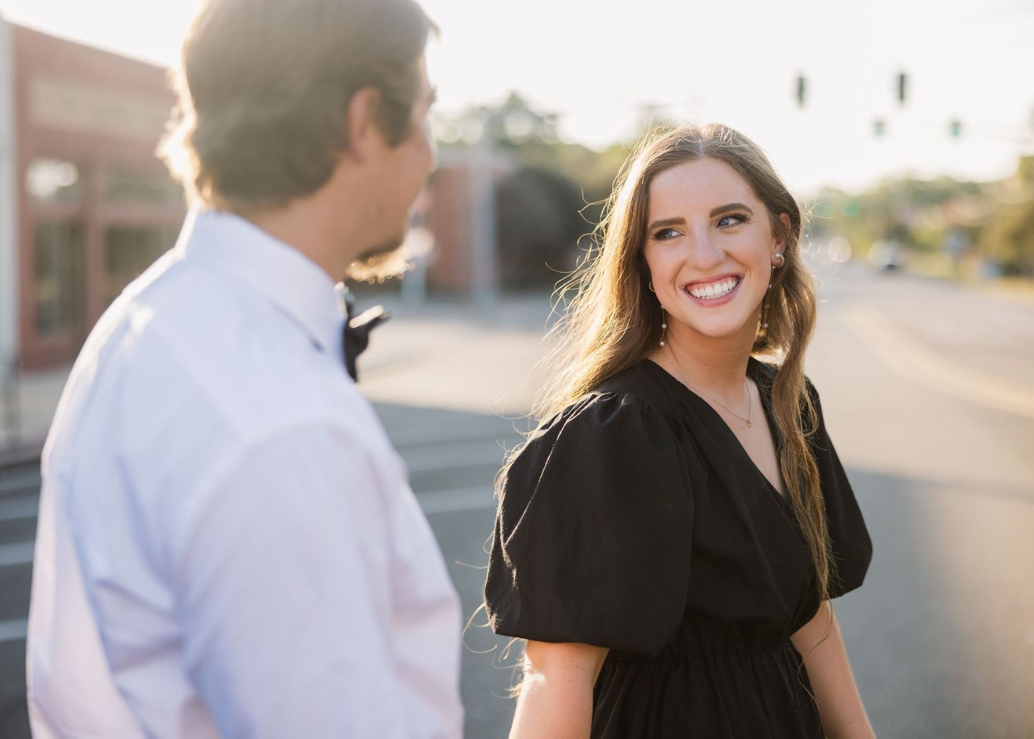 Candid couple laughing together during sunset engagement session.