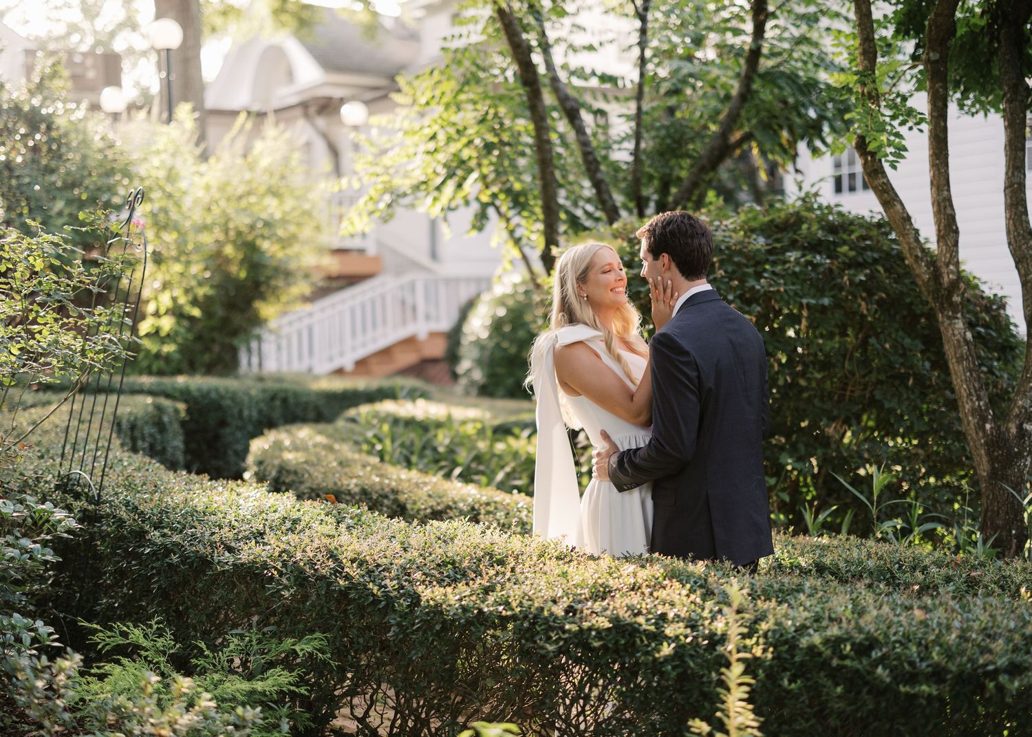 Golden sunlight filters through trees in elegant outdoor wedding setting.
