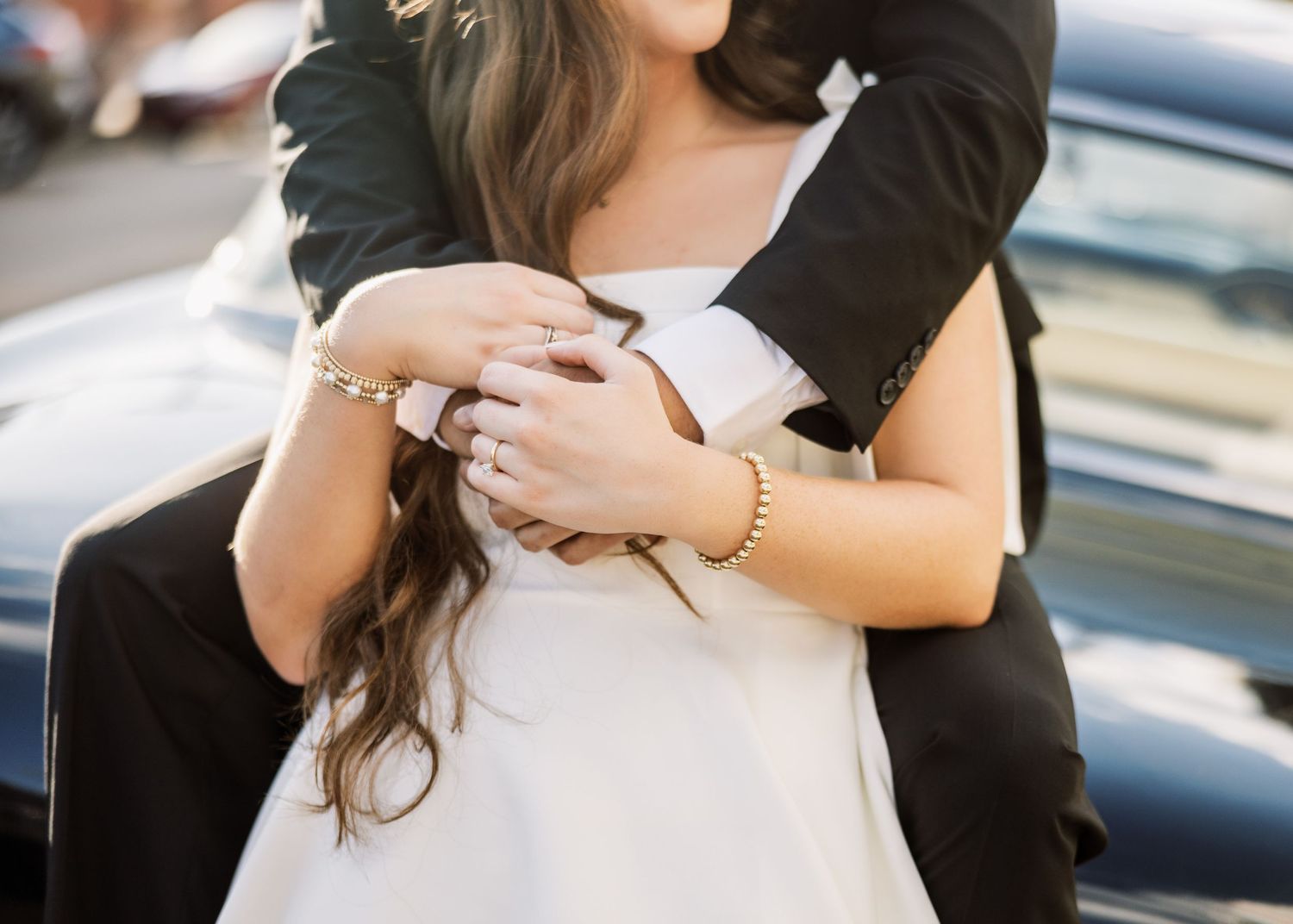 Intimate portrait session showing couple embracing in formal attire.