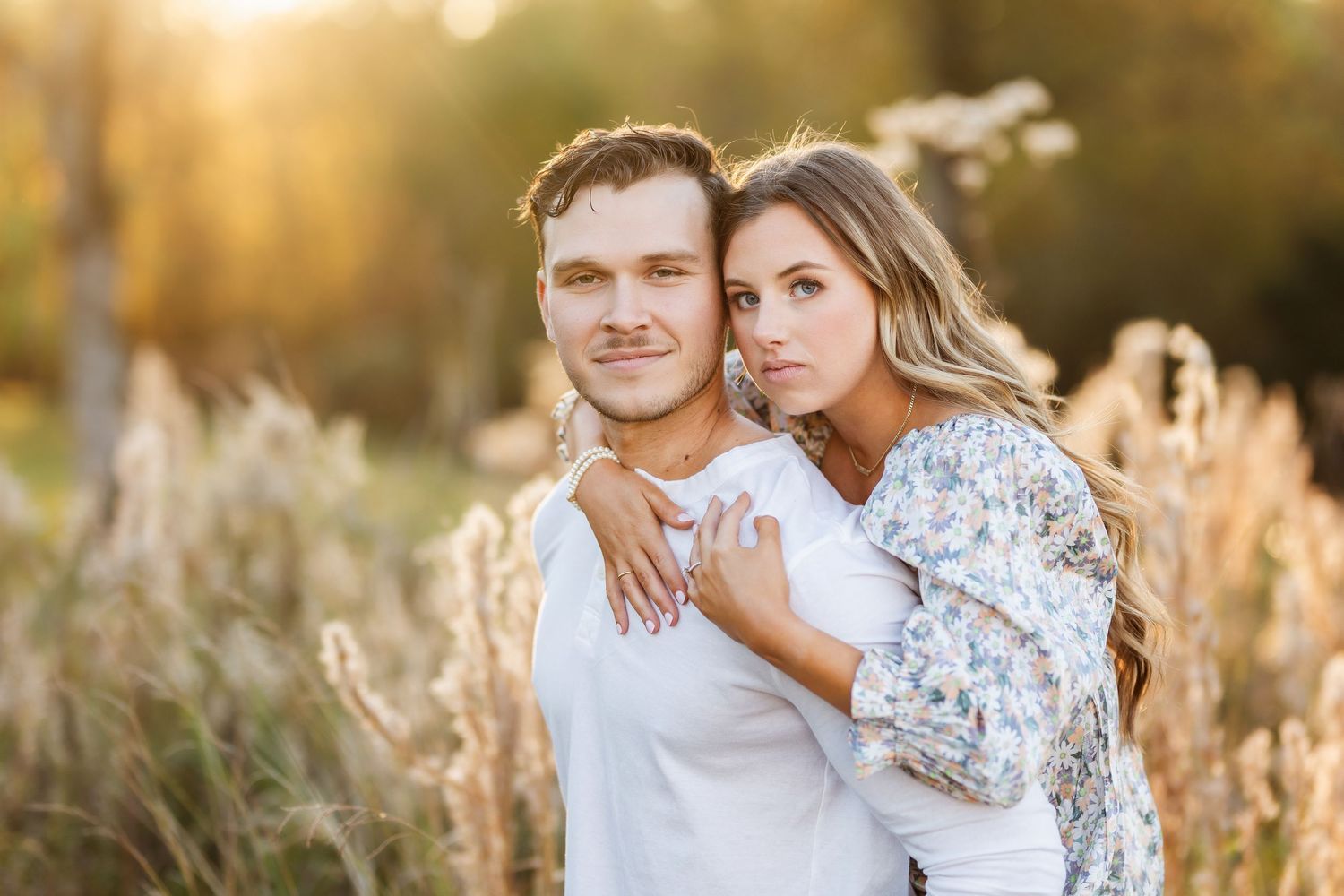 A romantic golden hour portrait session in a field of tall grass.