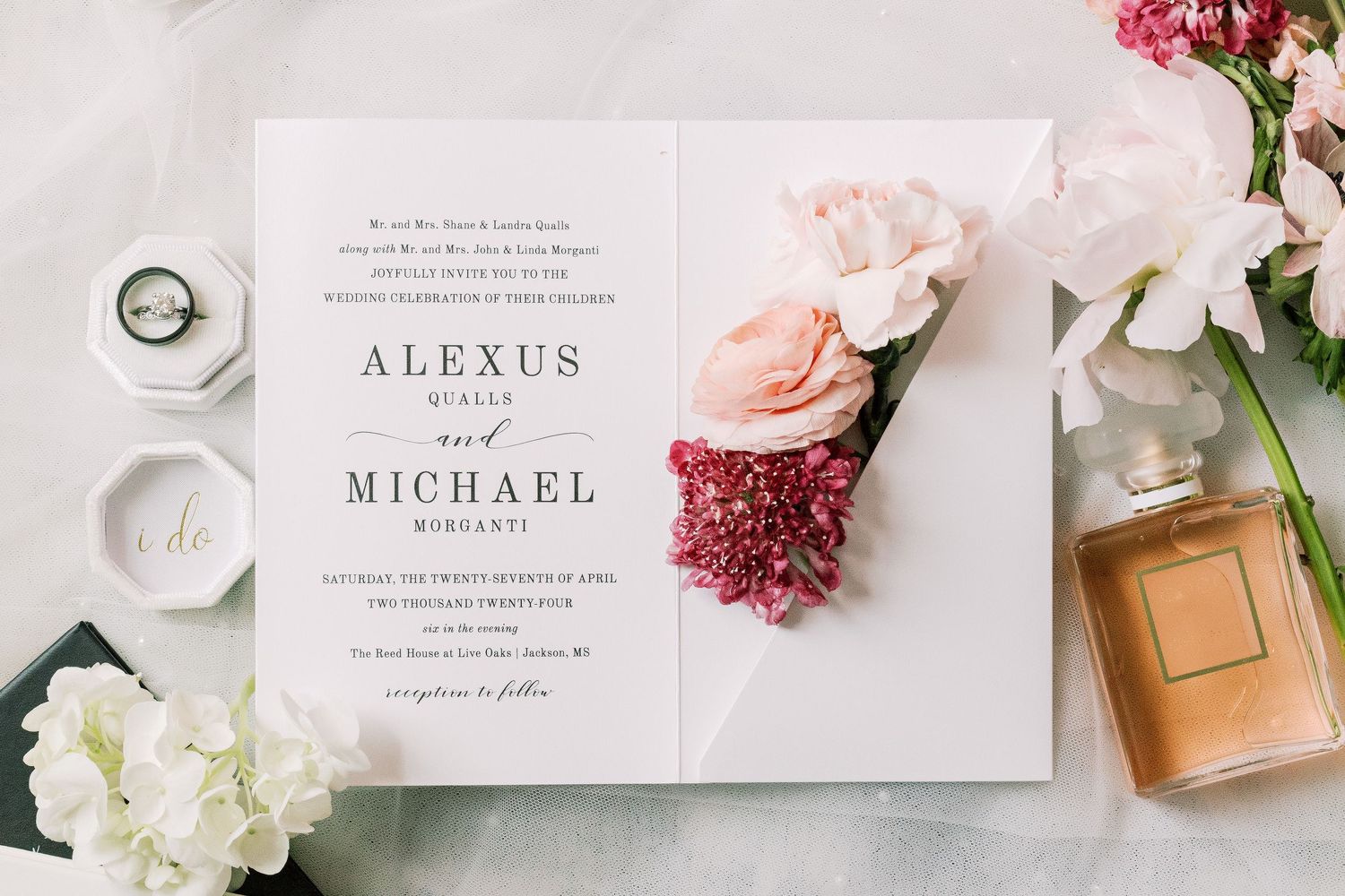 Elegant wedding invitations and florals in soft pink and blush tones with delicate details.