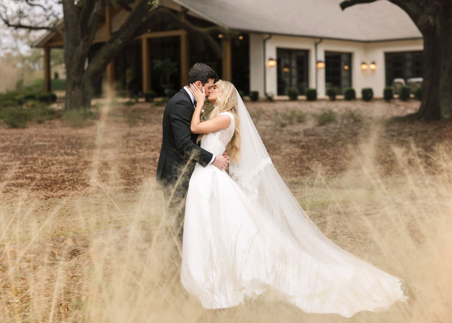Romantic wedding couple embraces in a golden wheat field during sunset creating a dreamy silhouette.