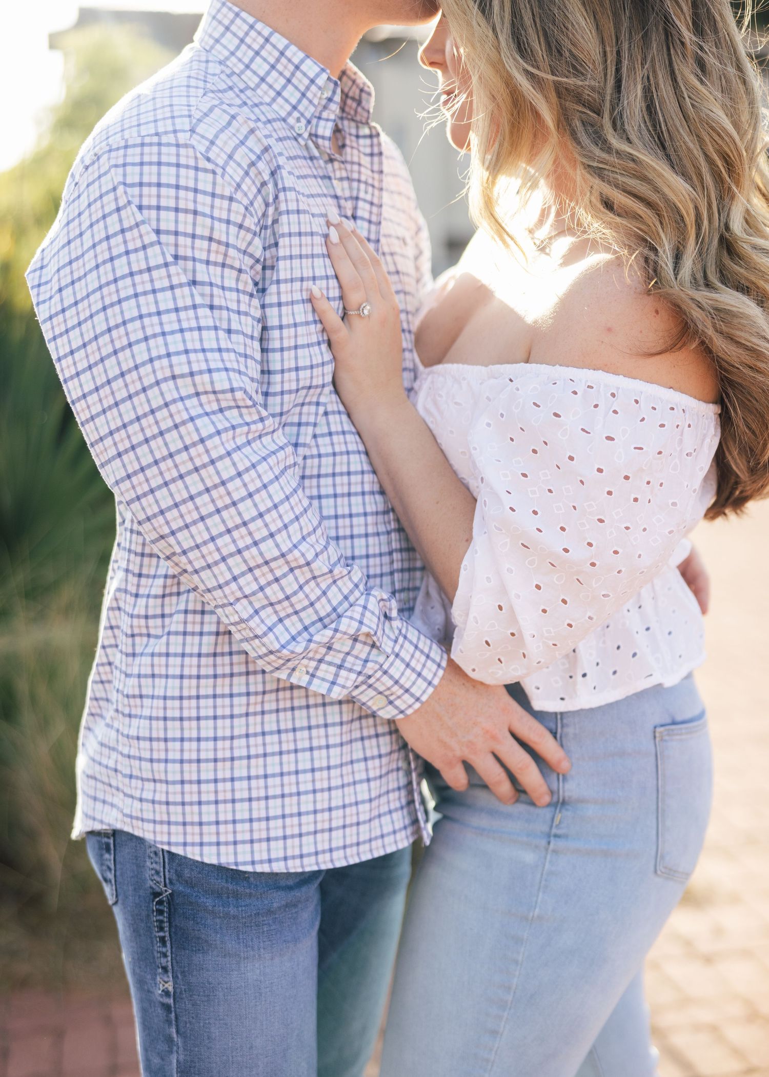 Intimate couple's portrait in casual attire during golden hour.
