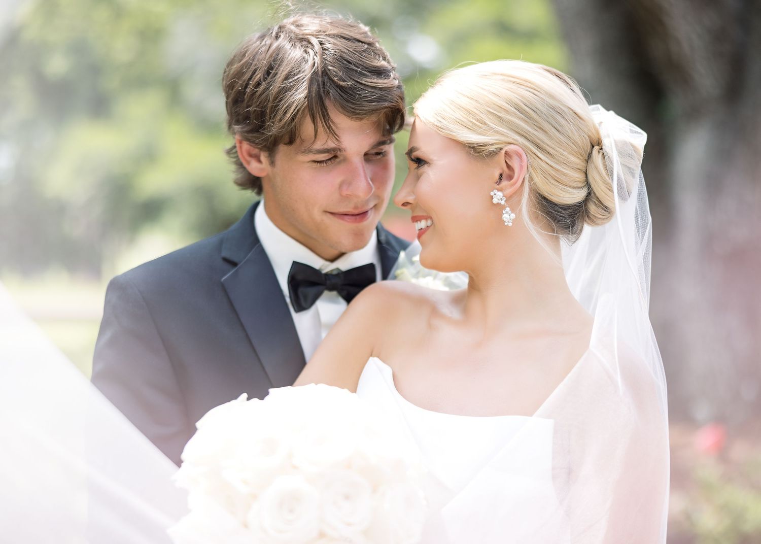 An intimate wedding portrait captured in soft lighting with a romantic feel.