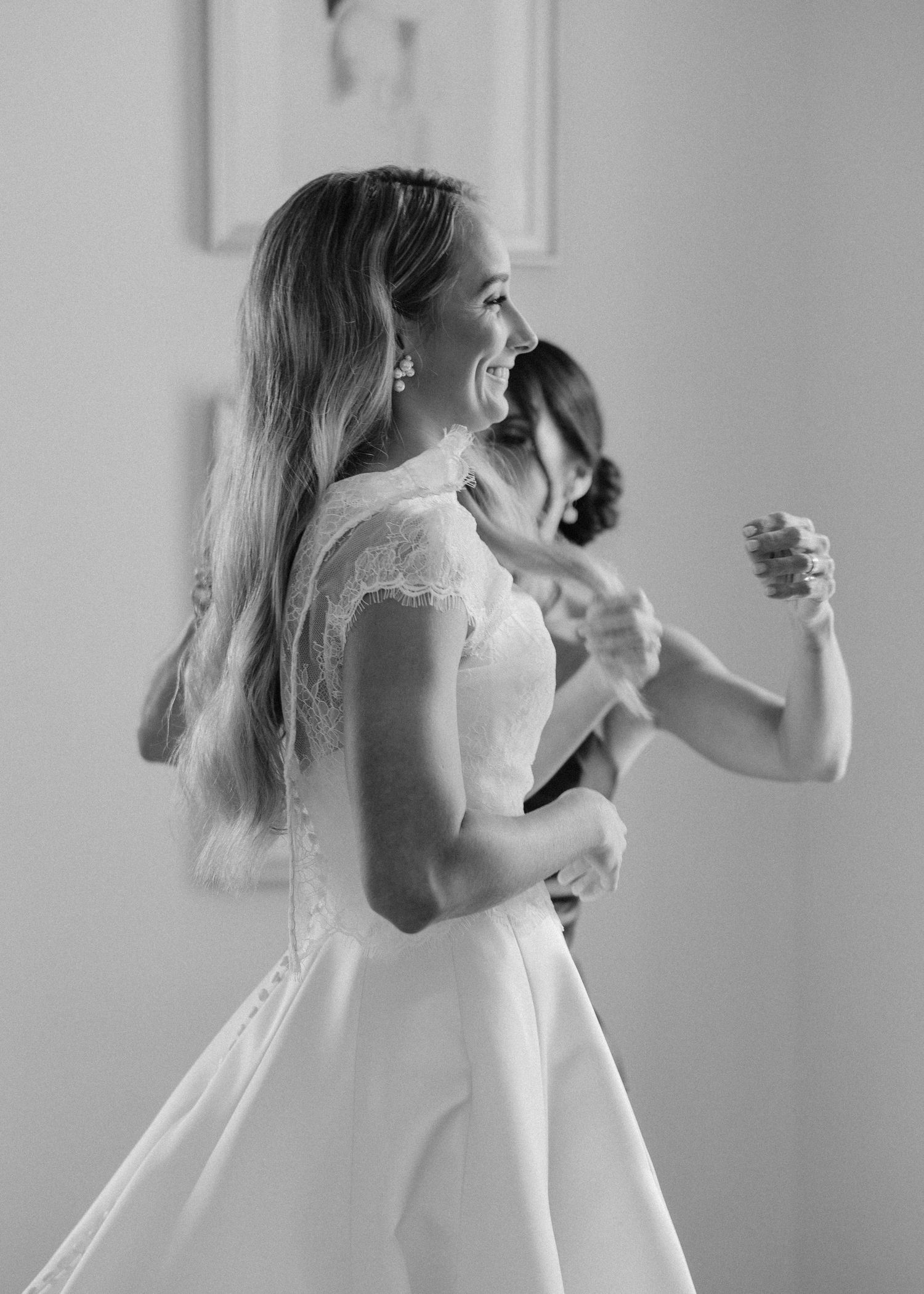 A series of black and white photos showing a person in a white dress laughing and expressing joyful emotions.