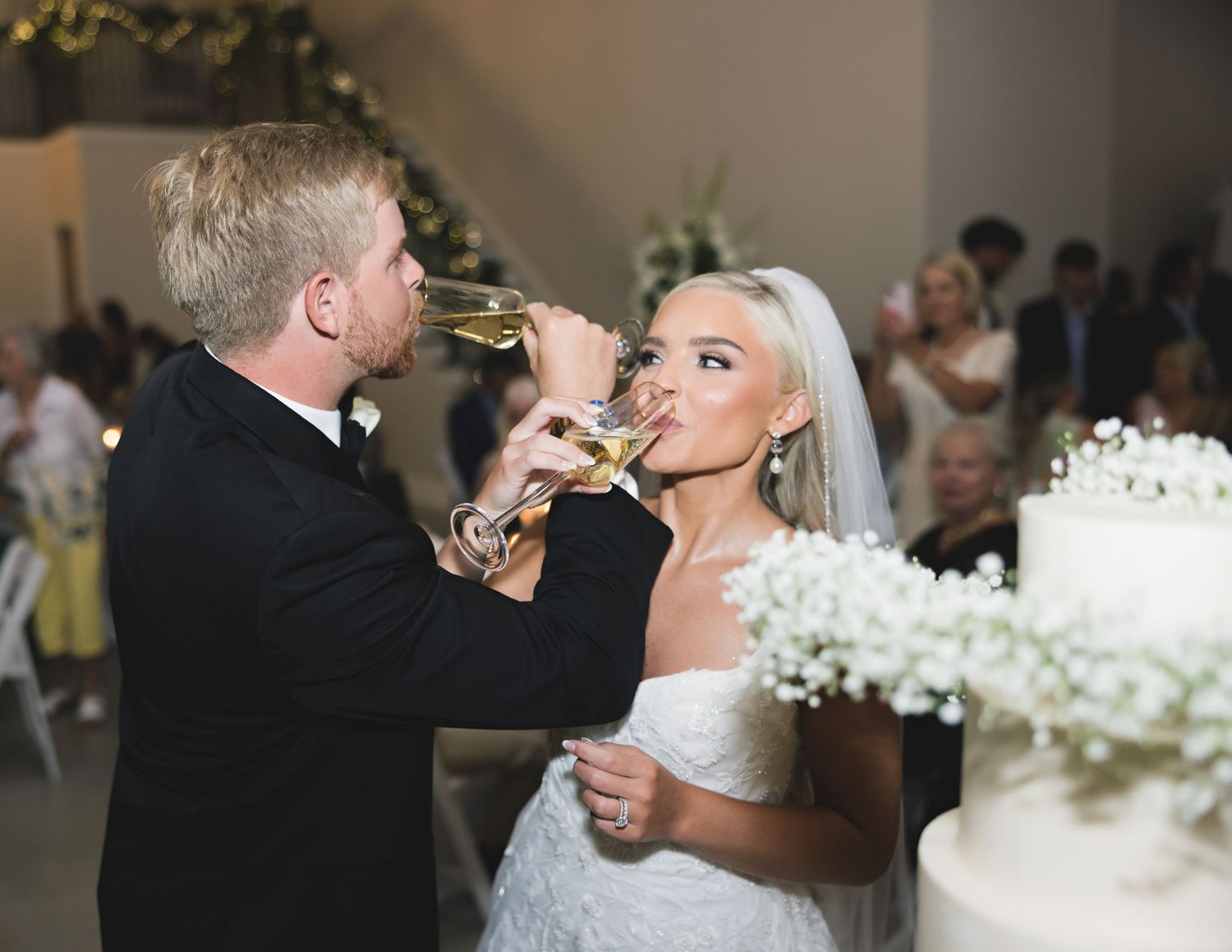 Traditional wedding champagne toast moment captured during reception celebration.