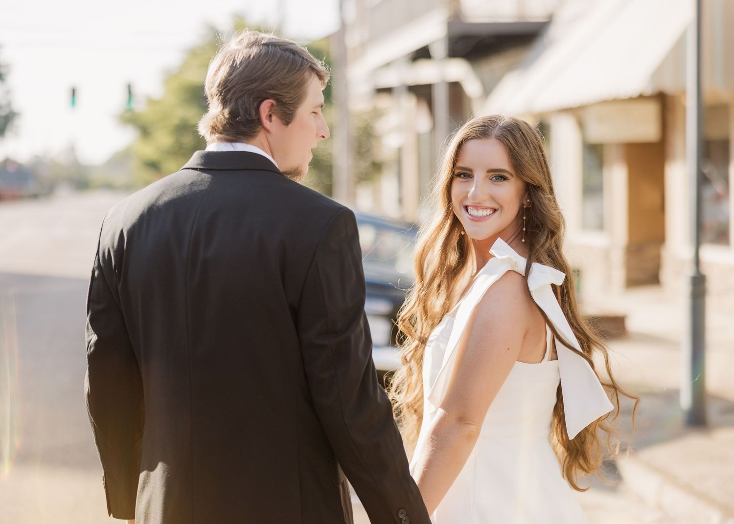 Romantic outdoor engagement photos captured in warm sunset lighting.