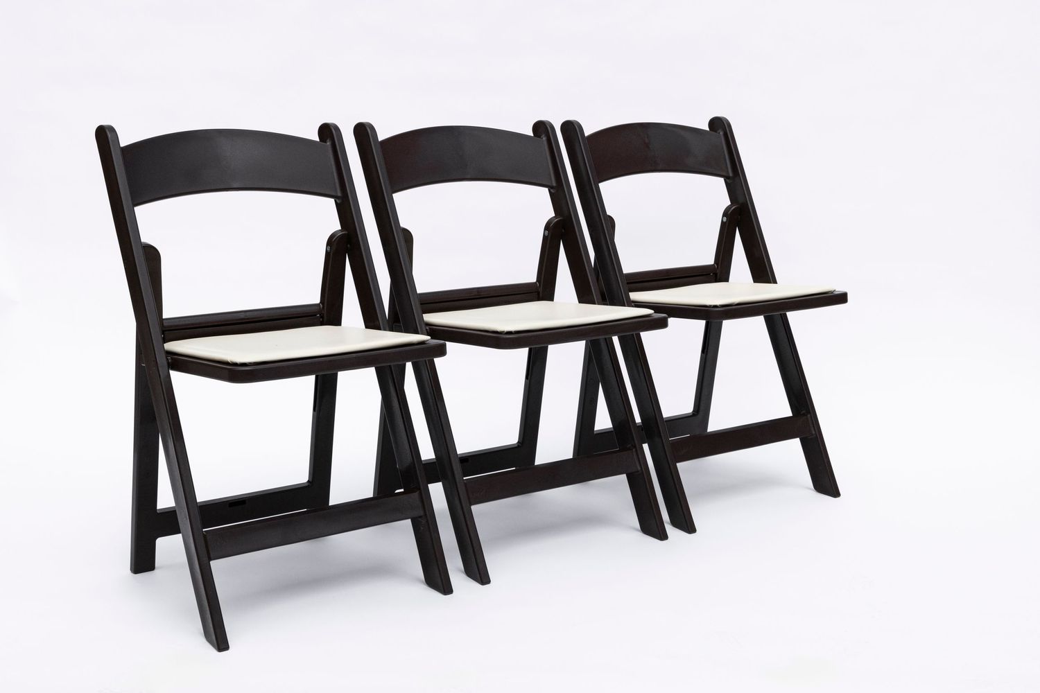 Black folding chairs arranged in rows against white background.