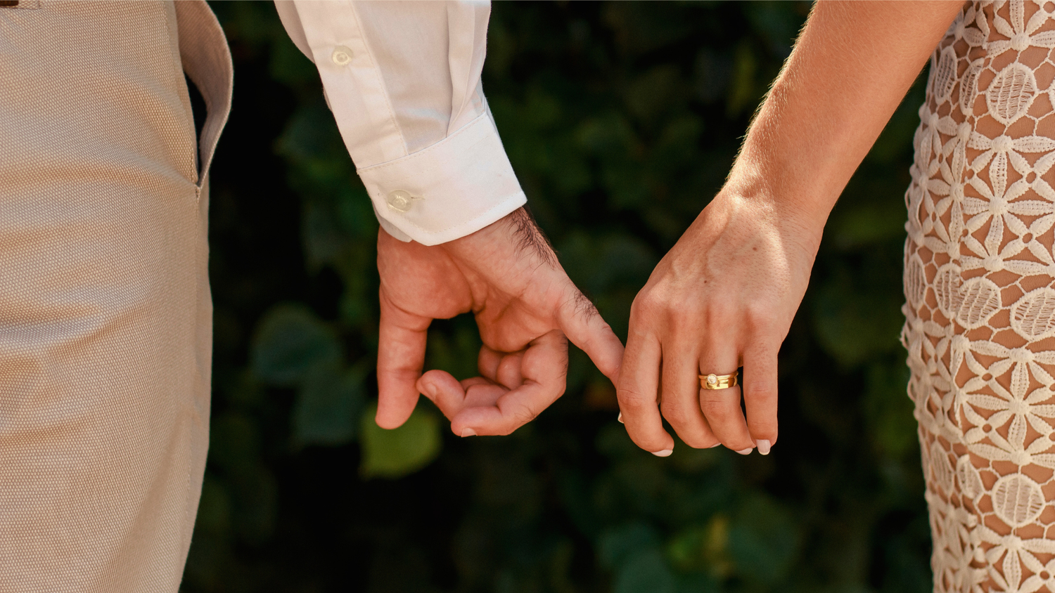 Hands holding out delicate lace and floral details.