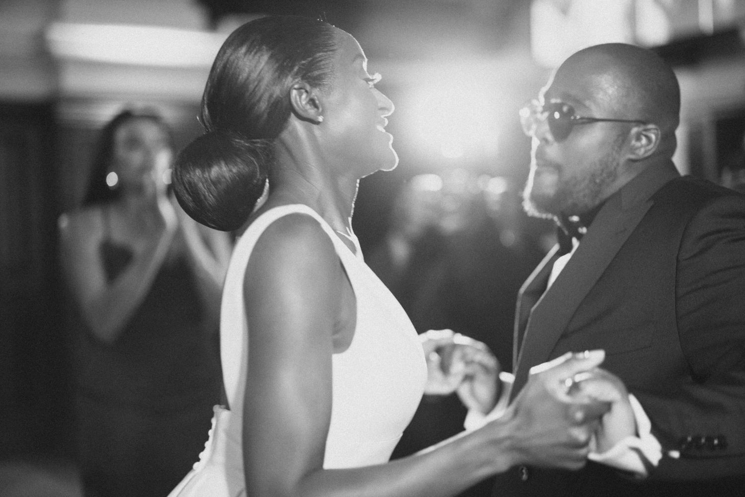 Black and white photo of couple dancing together in an intimate moment.