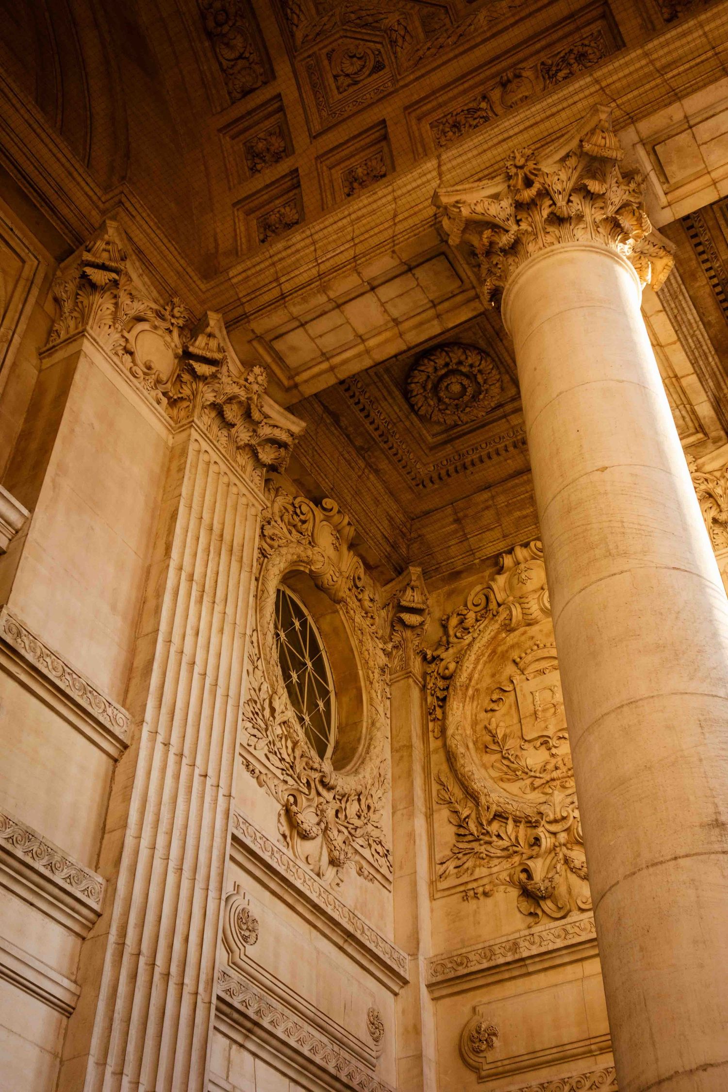 Ornate Baroque architectural details with fluted columns and gilded decorative elements adorn a grand interior ceiling.