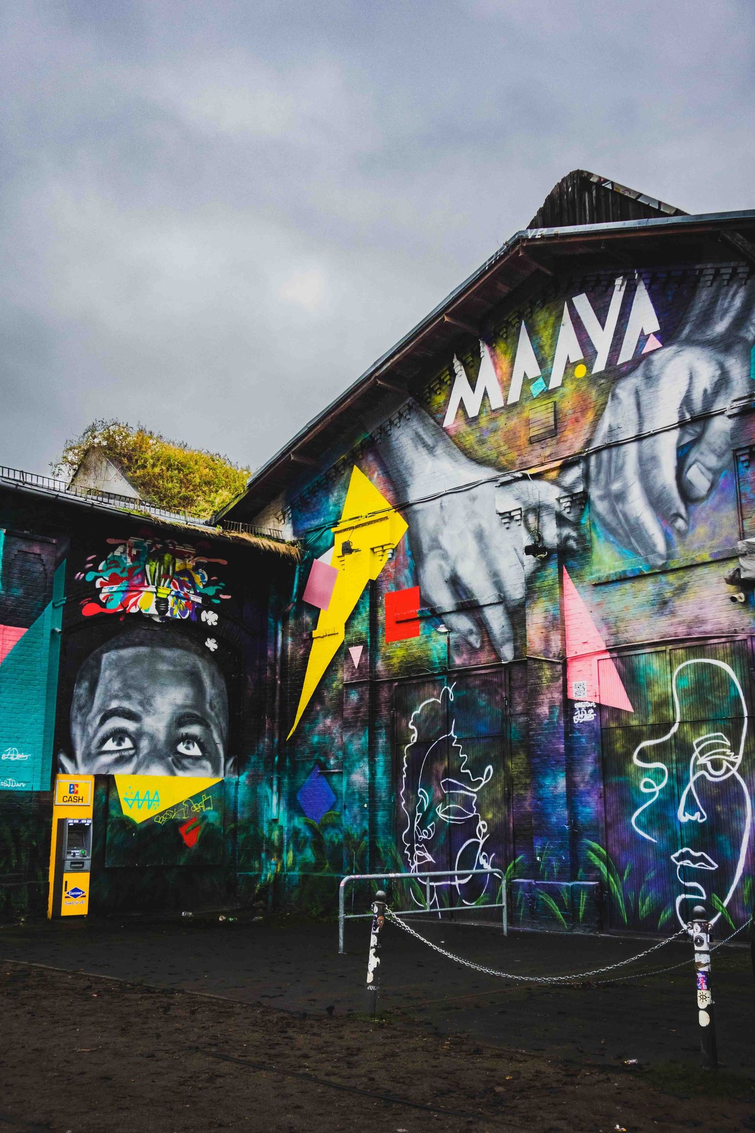Colorful street art and graffiti murals adorning walls of an urban building with 