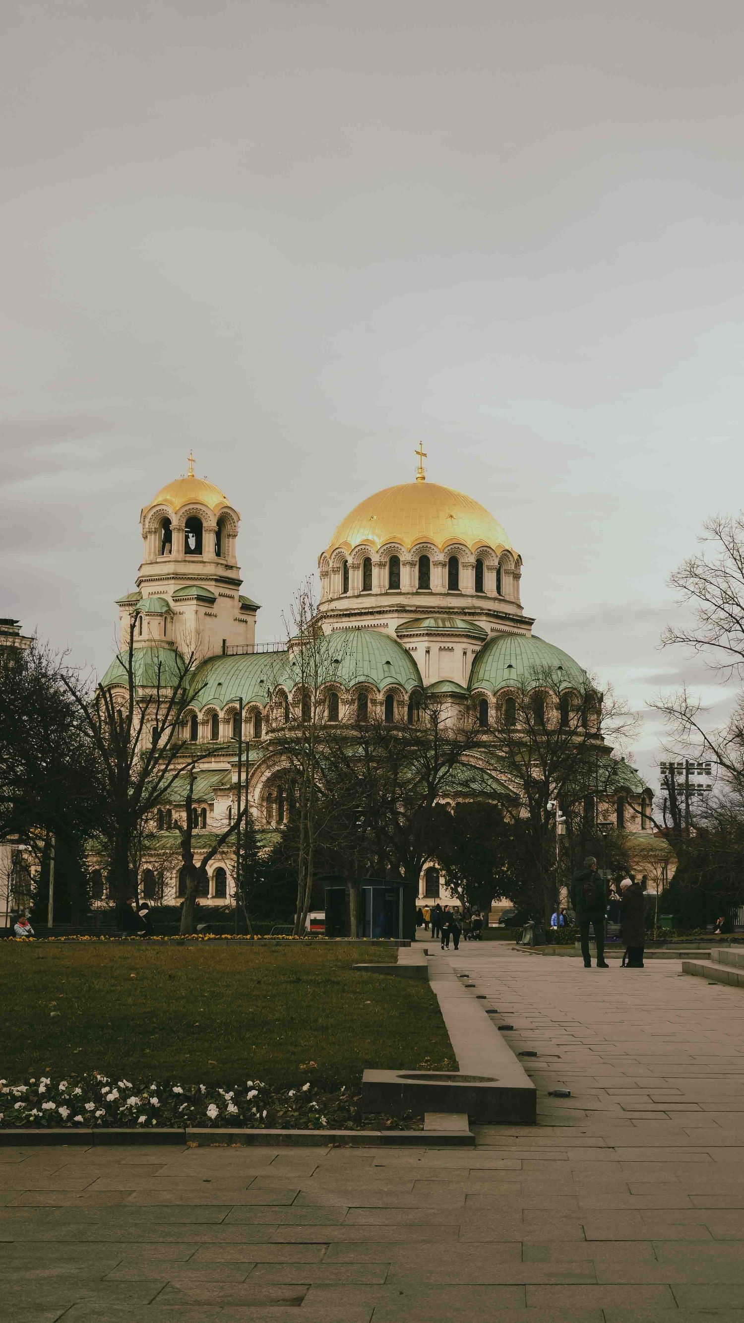 Ornate Alexander Nevsky Cathedral with golden domes stands majestically in Sofia, Bulgaria on a cloudy day.