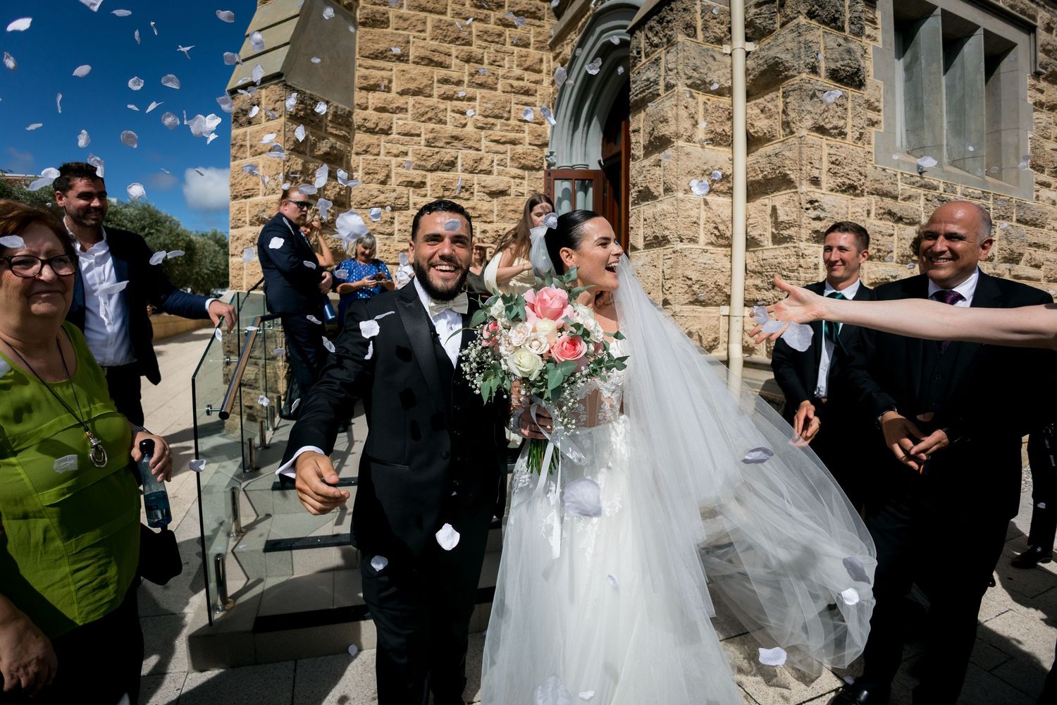 a christian wedding at cottlesloe star of the sea church, couple coming out from church, confetti candid moment captured by willie thow
