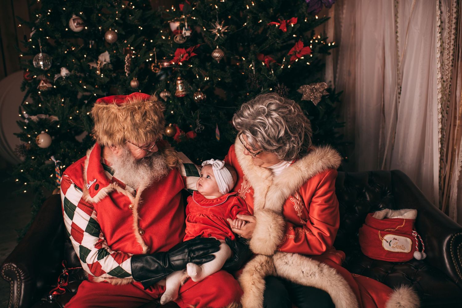 A series of four heartwarming photos showing tender moments between two people wearing red sweaters during Christmas.