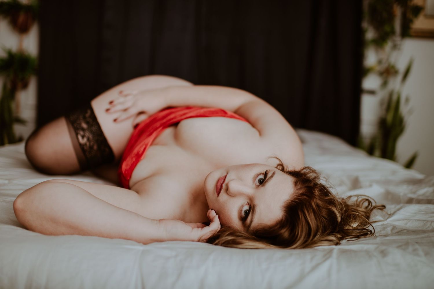 Intimate boudoir photography with red accents on white bedding. Vanceburg Ky