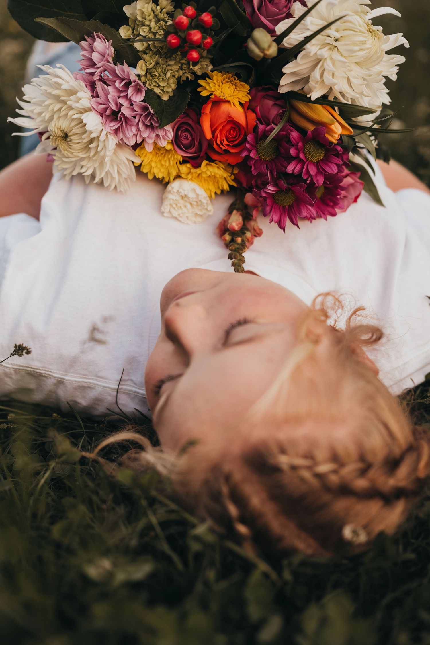A dreamy portrait with colorful flowers framing the composition against dark background.